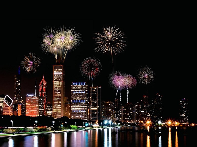 Fireworks bursting over the lakefront towers at night