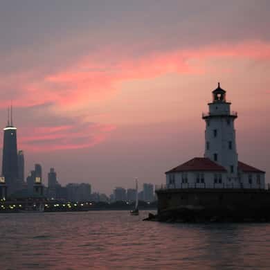 The harbor lighthouse against a sunset sky