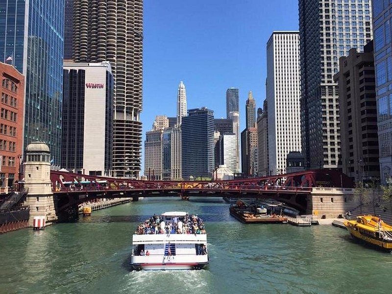 A sightseeing boat on the river, a line of bridges behind it