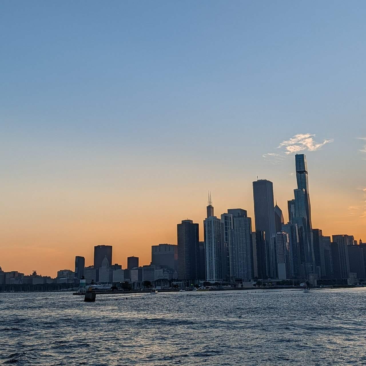 The skyline in silhouette against an orange sky just after sunset